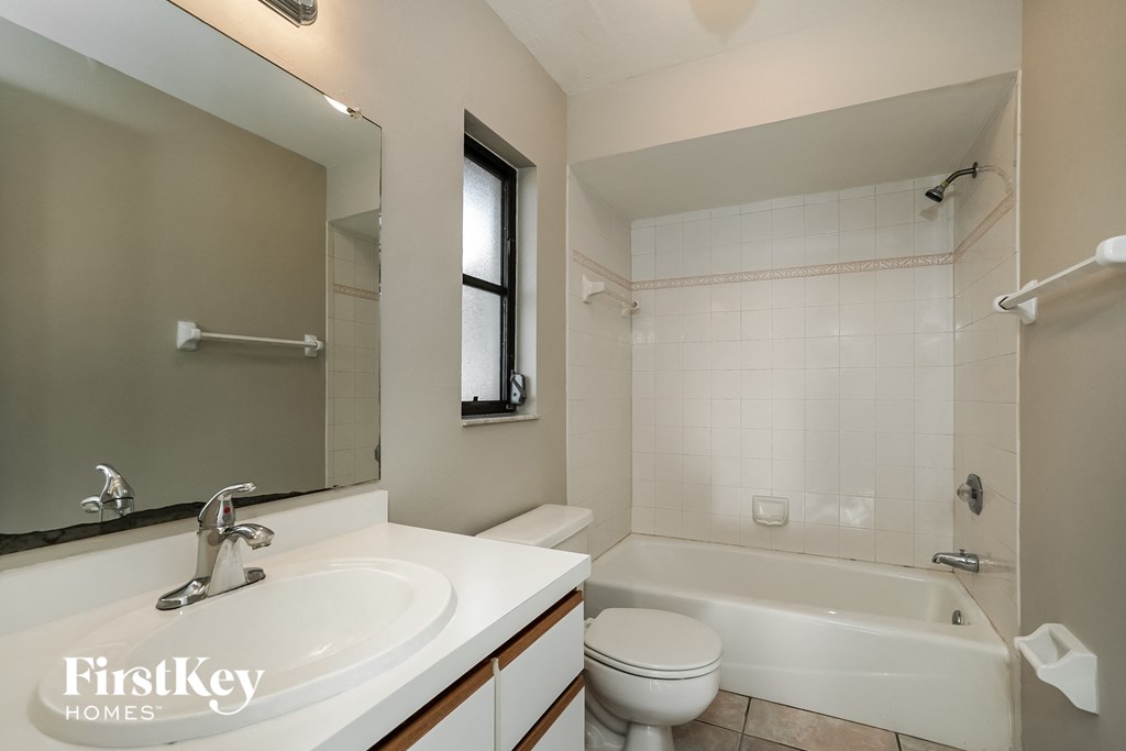 a bathroom with a sink toilet and a bath tub