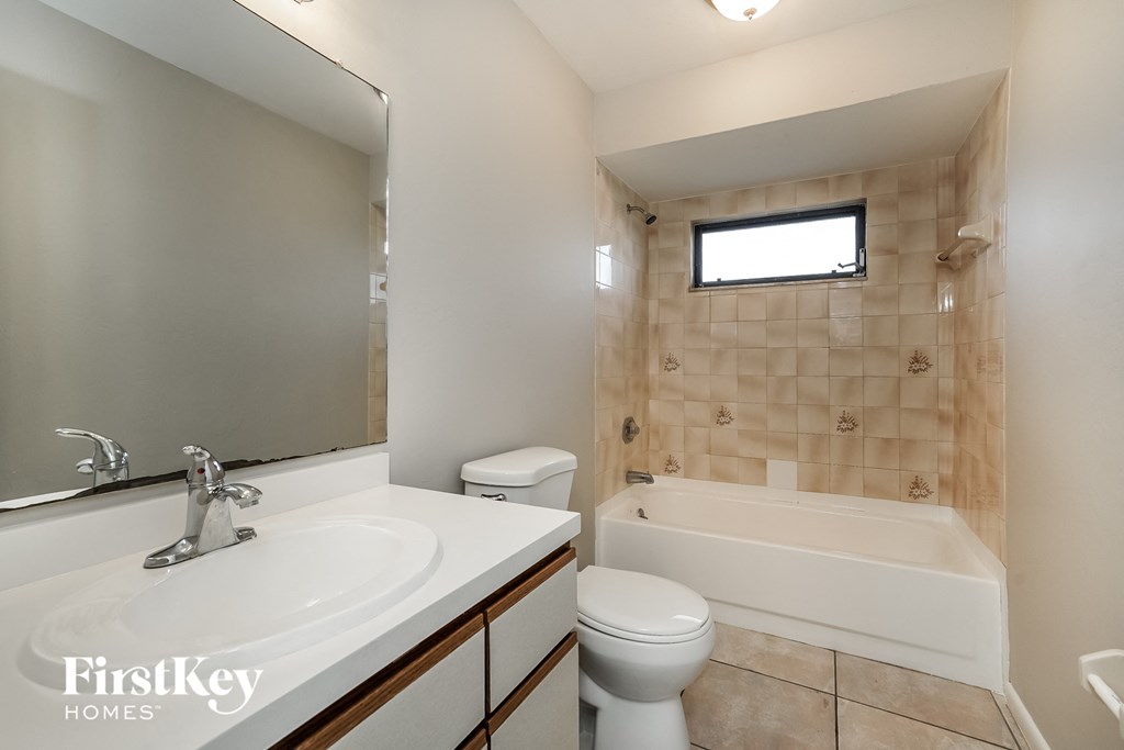 a bathroom with a sink and a toilet and a bath tub