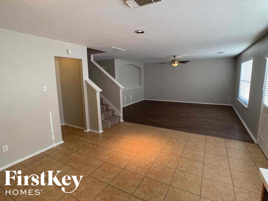 A room with a FirstKey Homes logo on the bottom left corner.