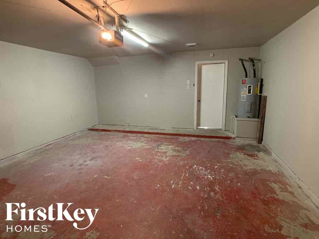 A room with a red floor and a white door.