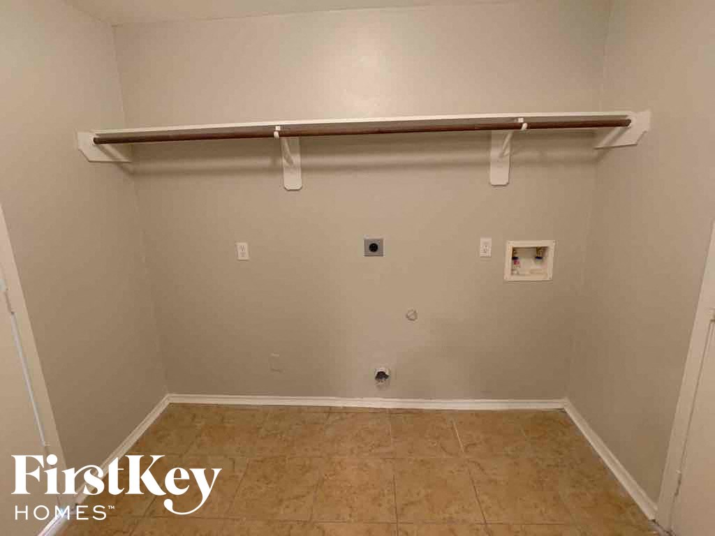 A room with a white wall and a wooden floor.