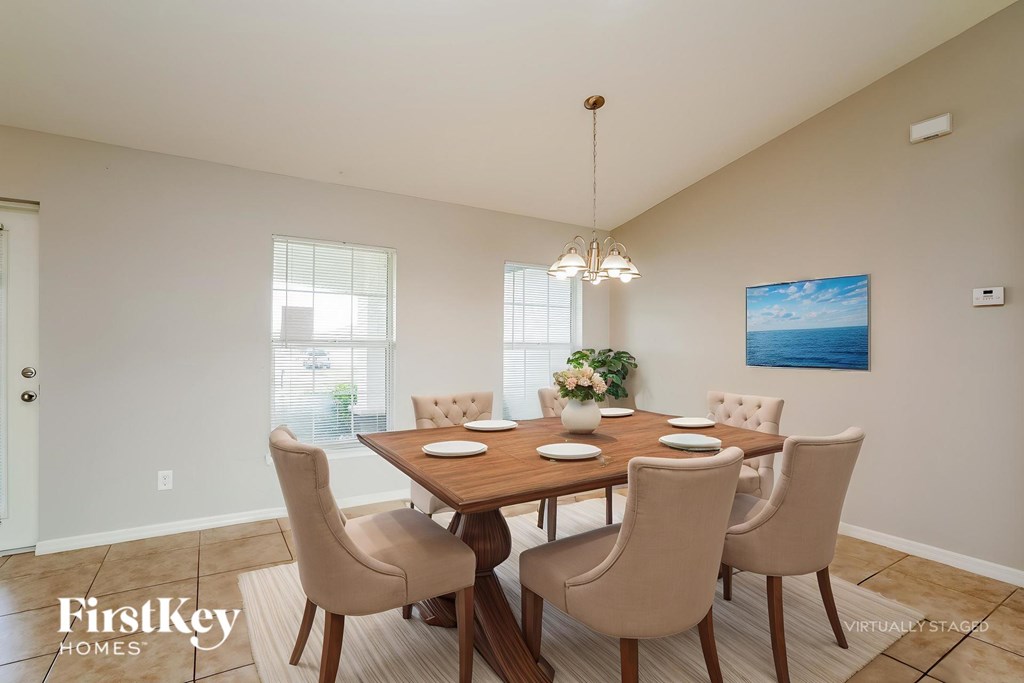A dining room with a wooden table and chairs.