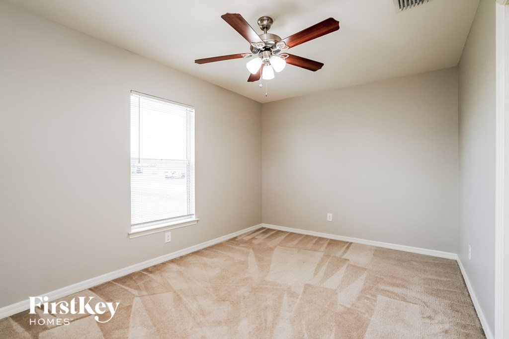 A room with a fan and a window.