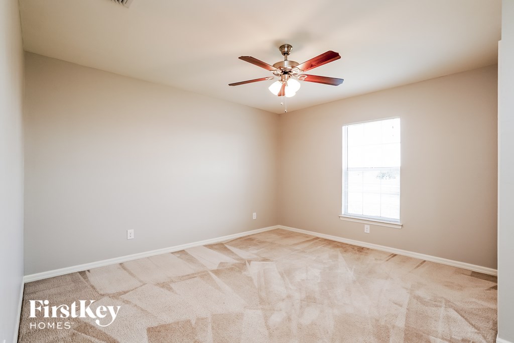 A room with a fan and a window.