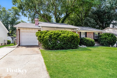 A house with a garage and a well-kept lawn.