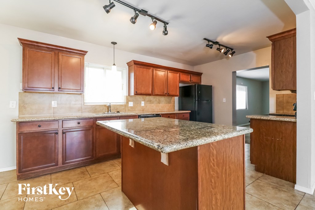 full view of kitchen with granite counter tops and wooden cabinets