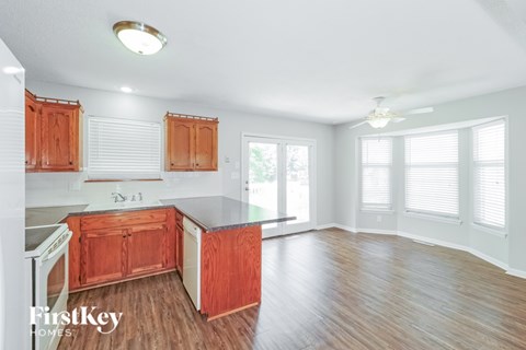 A kitchen with wooden cabinets and a refrigerator.