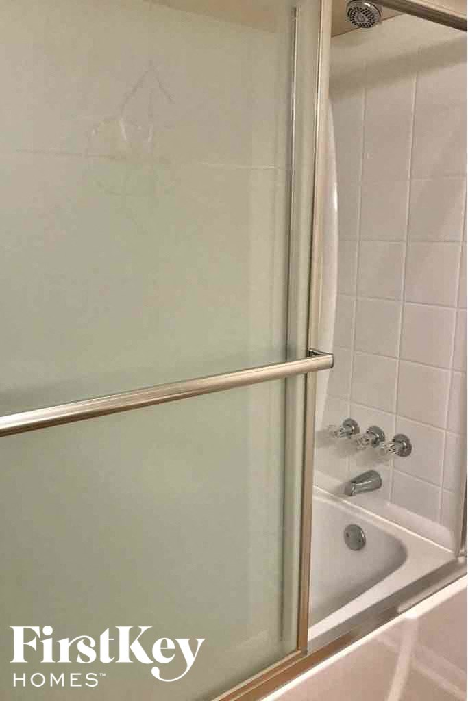 a bathroom with a shower and a bath tub