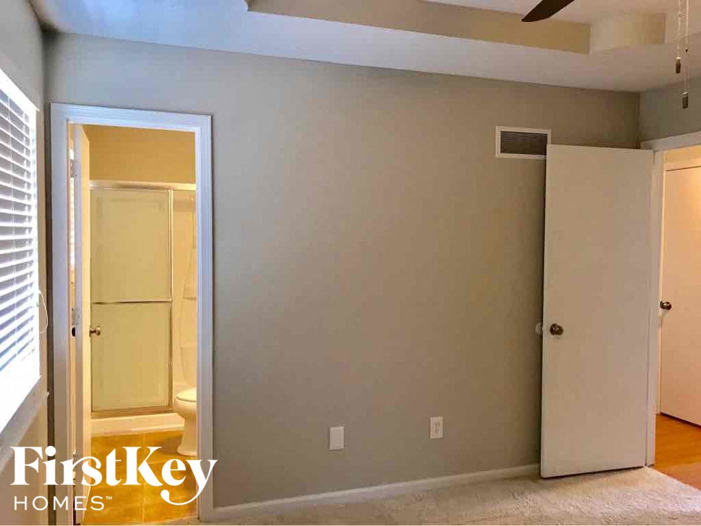 an empty room with a closet and a window and a door