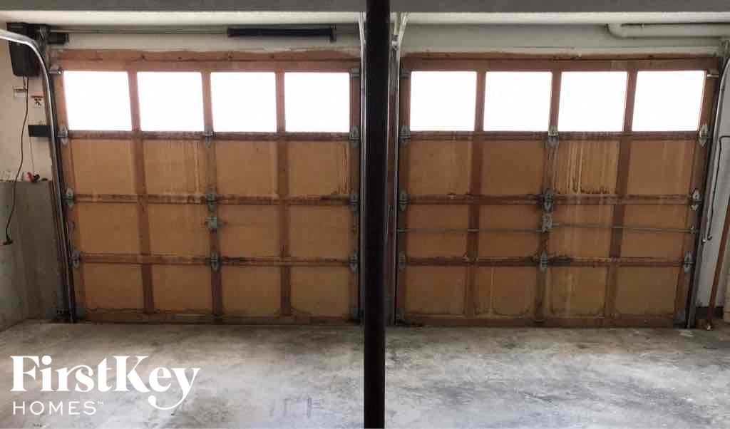 a garage door that has been boarded up with brown panels
