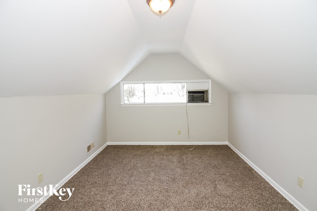 a room with a carpeted floor and a window