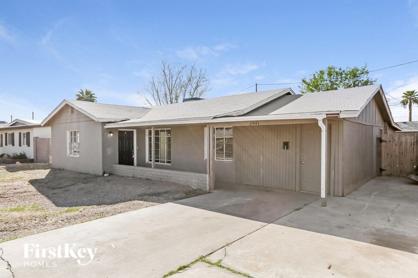 a small house with a driveway and a garage door