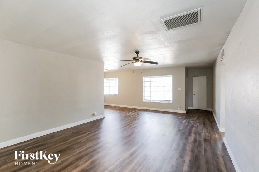 the living room and dining room of an empty house