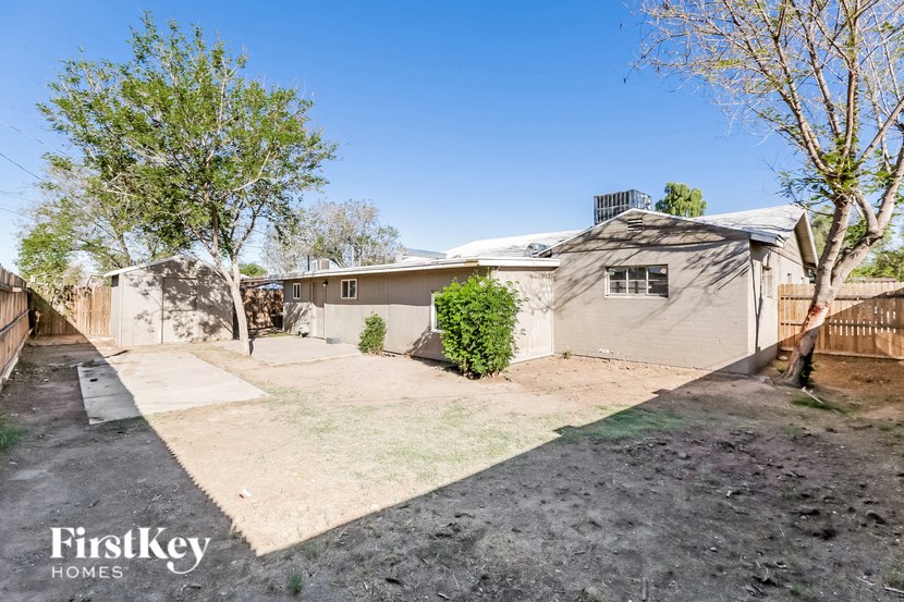 a white house with a yard and a fence