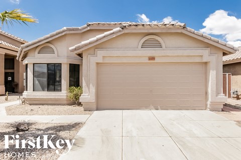 a single story home with a white garage door