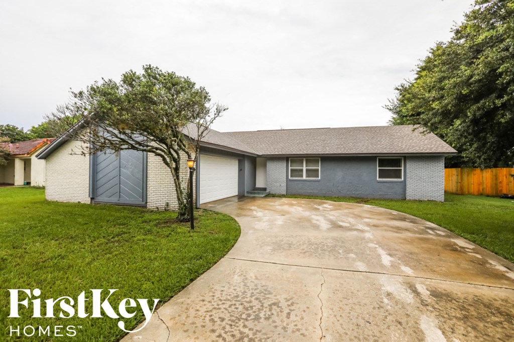 a house with a driveway and a blue garage door