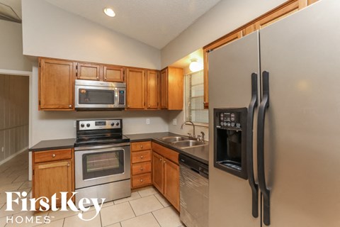 a kitchen with stainless steel appliances and wooden cabinets