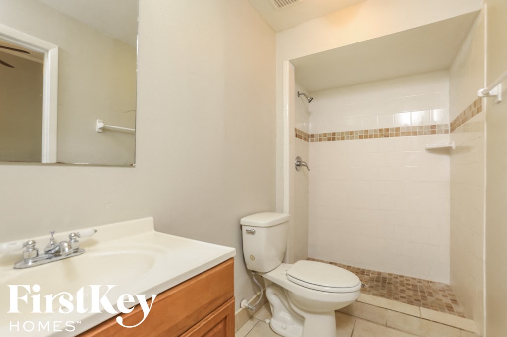 a bathroom with a toilet and a sink and a mirror