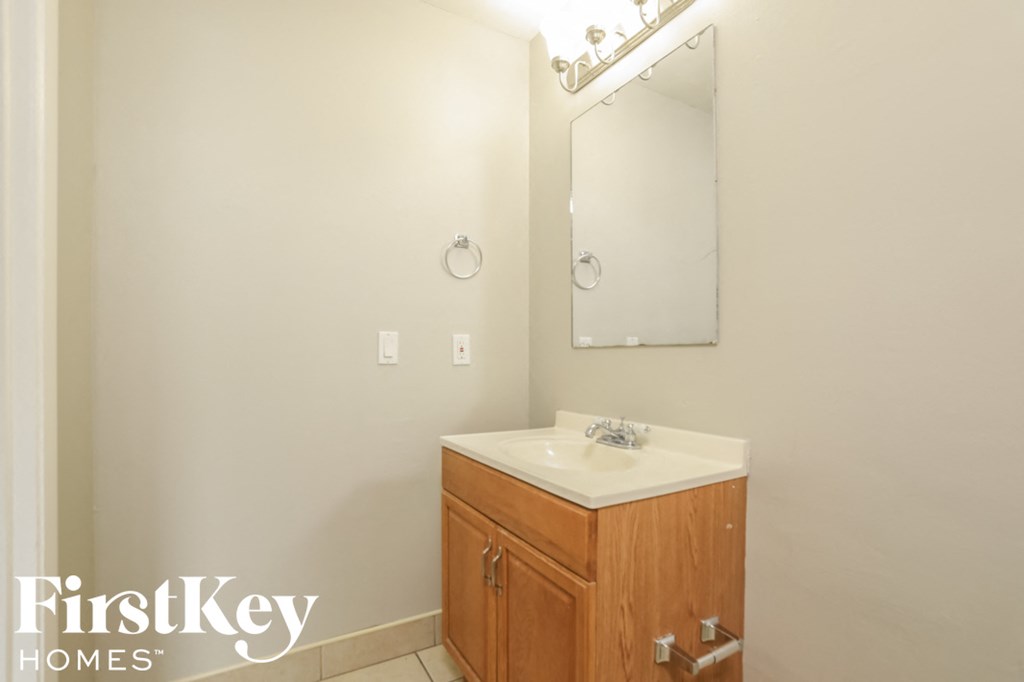 a small bathroom with a sink and a mirror