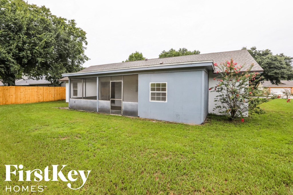 the backyard of a house with a yard and a fence
