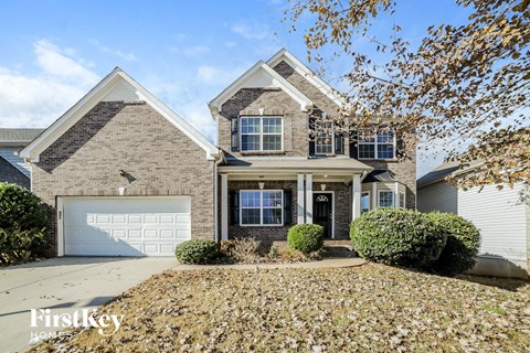 a large brick house with a white garage door