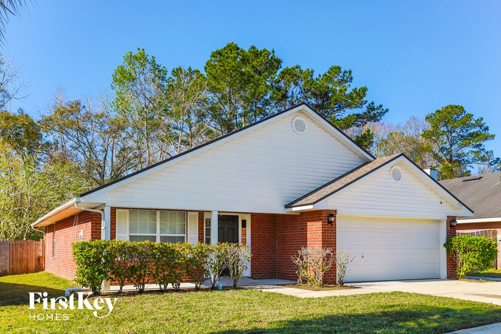 A house with a red brick exterior and a white garage door.