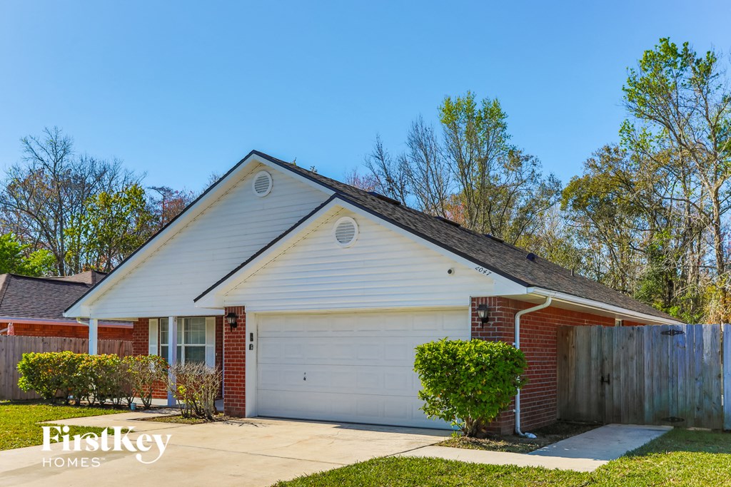 A house with a garage is for sale.