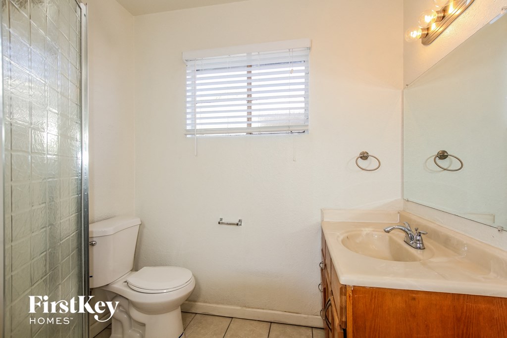 a bathroom with a toilet and a sink and a shower