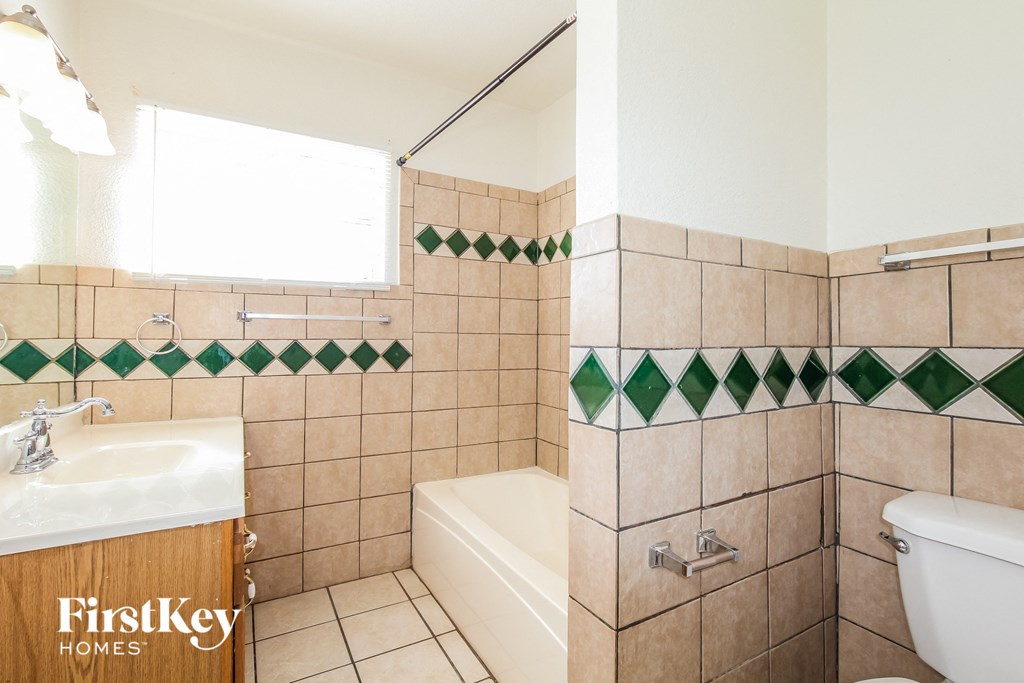 a bathroom with a sink toilet and a bath tub