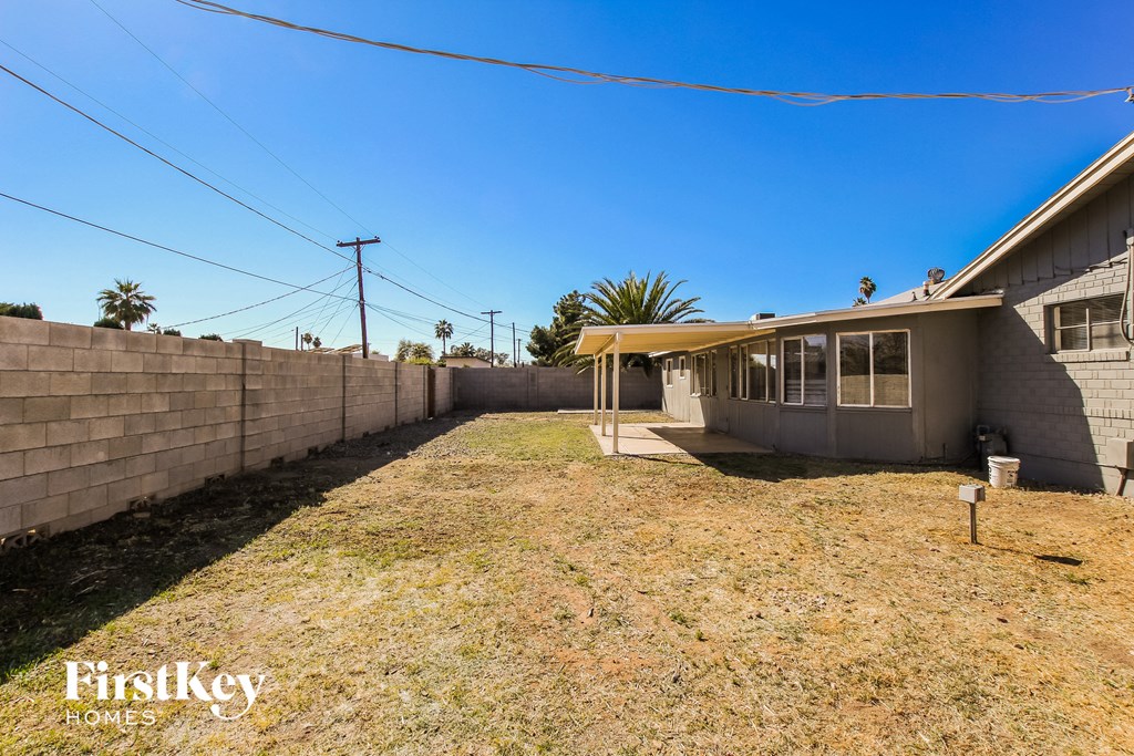 the backyard of a house with a yard and a fence