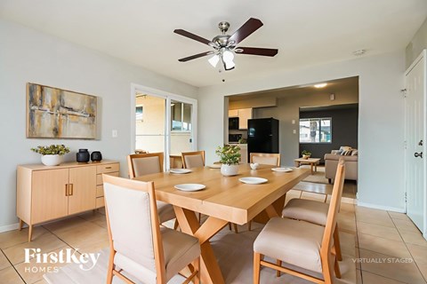 A dining room with a wooden table and chairs.