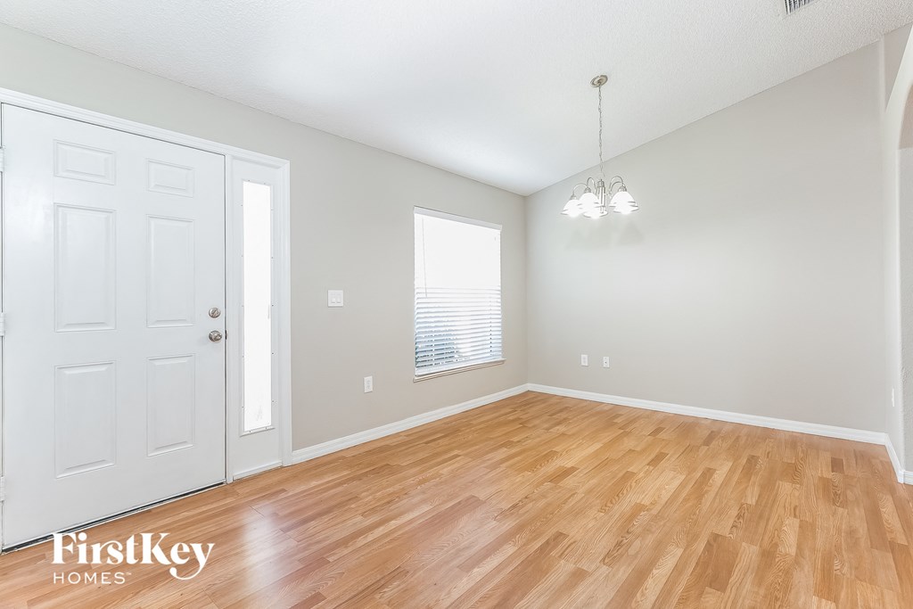 the living room and dining room with wood flooring