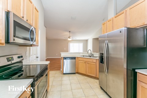 a kitchen with stainless steel appliances and wooden cabinets