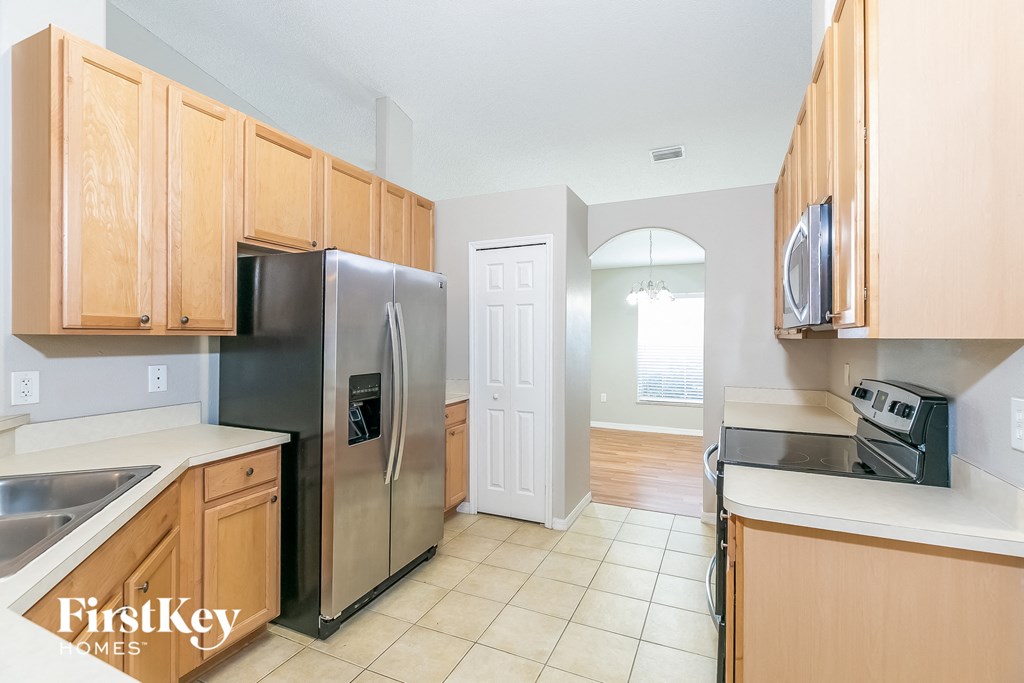 a kitchen with wooden cabinets and stainless steel appliances
