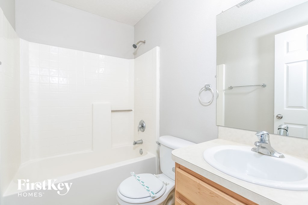 a bathroom with a sink and a toilet and a tub