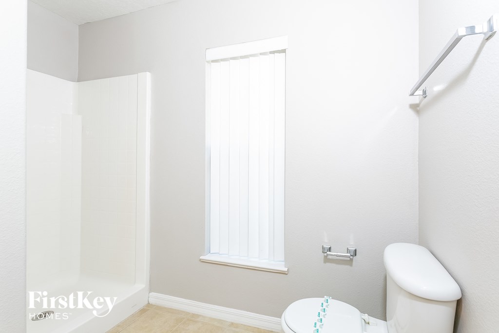 a small bathroom with a toilet and a shower