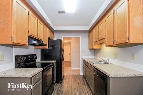 a kitchen with black appliances and granite counter tops