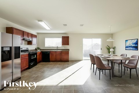 A modern kitchen with a dining table set for six.