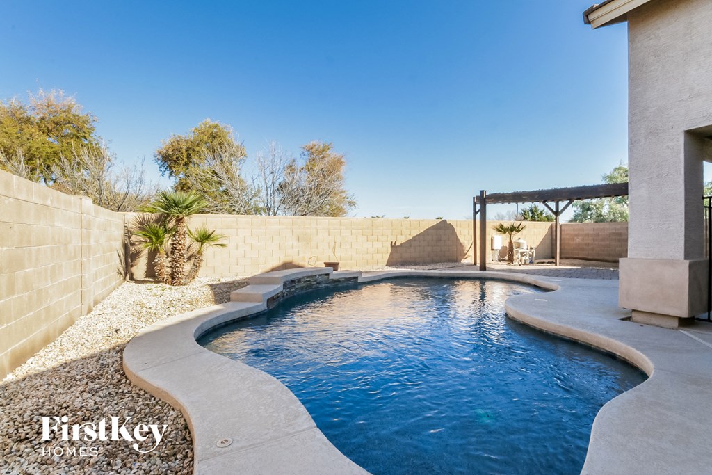 a swimming pool in a backyard next to a house