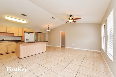 A kitchen with wooden cabinets and a beige island.