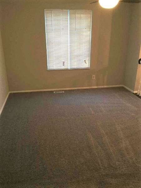 an empty living room with a window