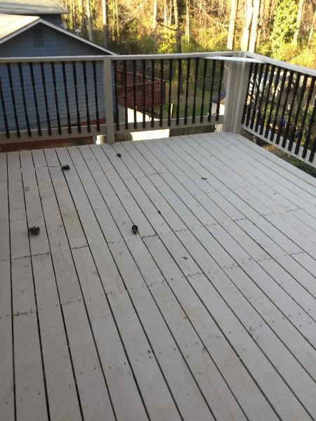 a deck with wooden floors and a metal railing