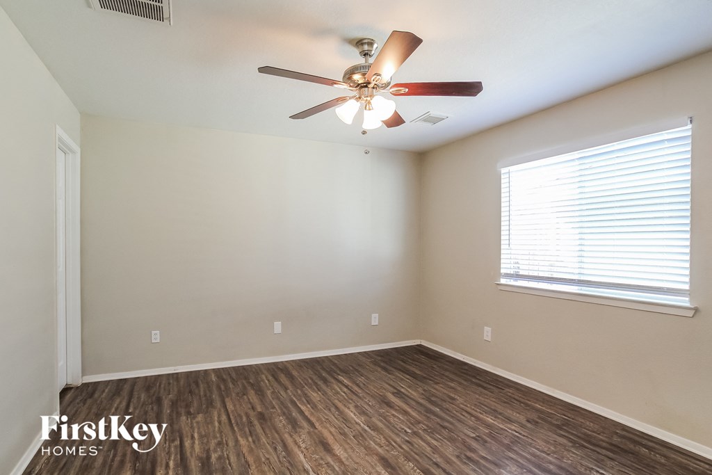 a living room with a ceiling fan and a window