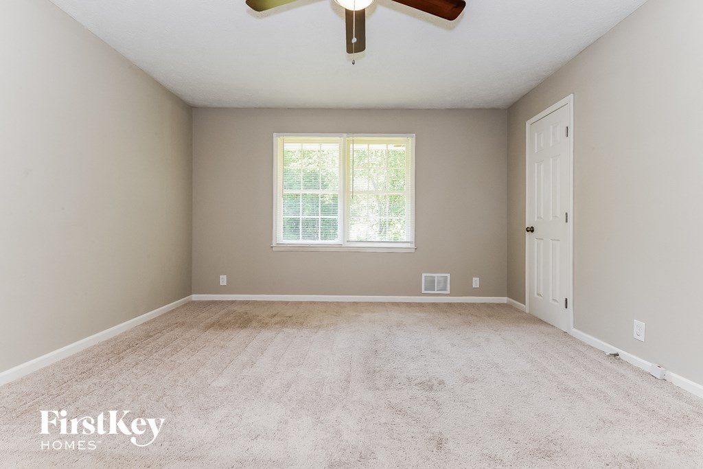 the master bedroom is spacious and has a ceiling fan