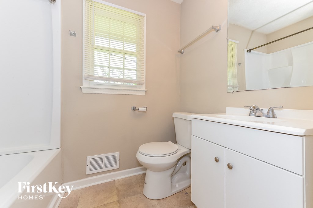 a bathroom with a toilet and a sink and a shower