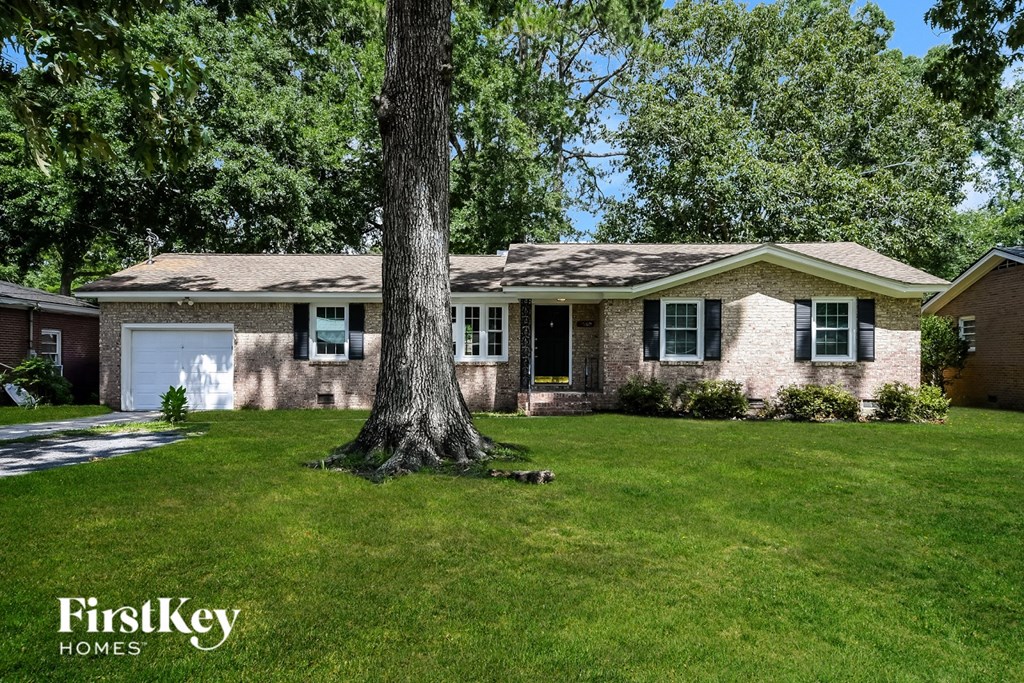 A house with a tree in front of it.