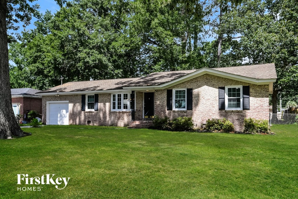 A house with a white garage door and a brick exterior.
