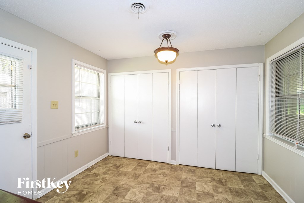 a bedroom with two closets and a light on the ceiling
