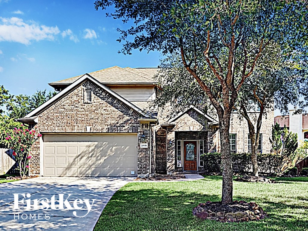 A house with a tree in front of it.