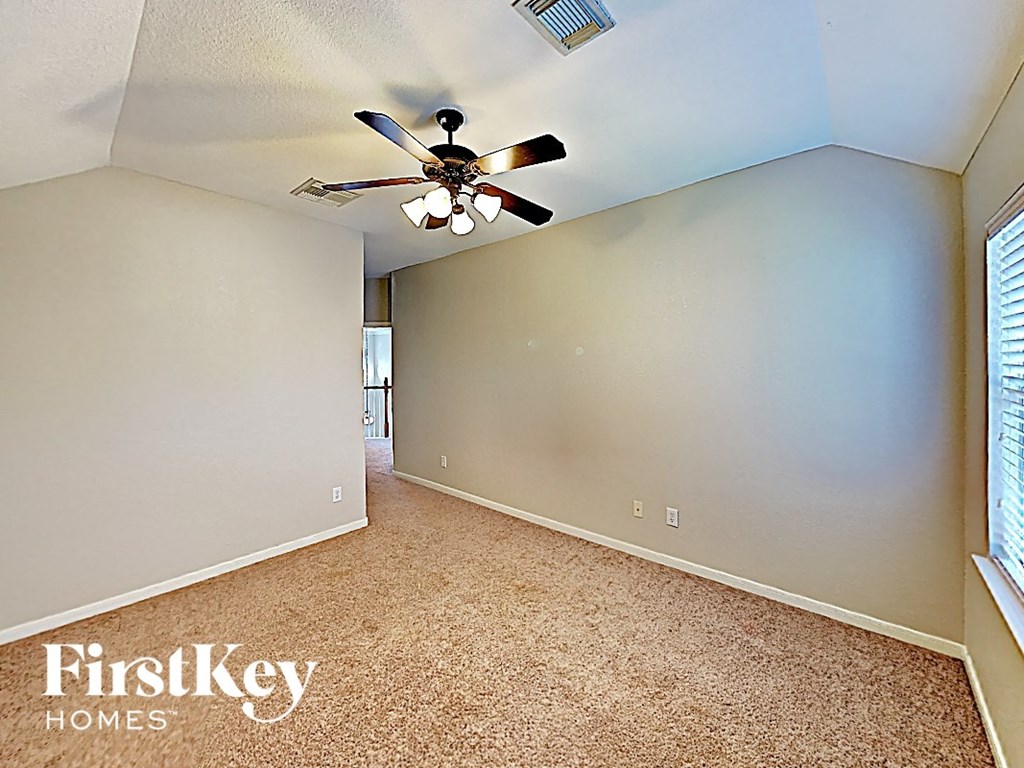 A room with a fan and carpeting is for sale.